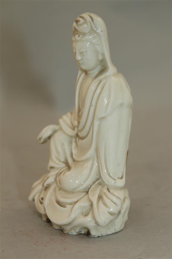 A Chinese blanc de chine seated figure of Guanyin, Dehua, 18th / 19th century, 11cm, losses to fingers